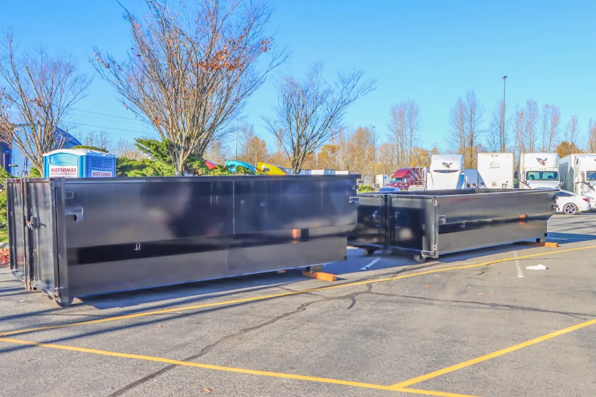 Professional dumpster rental service with roll-off container on residential driveway in Pleasant Run